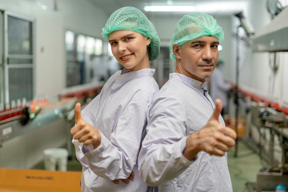 food production workers give thumbs up